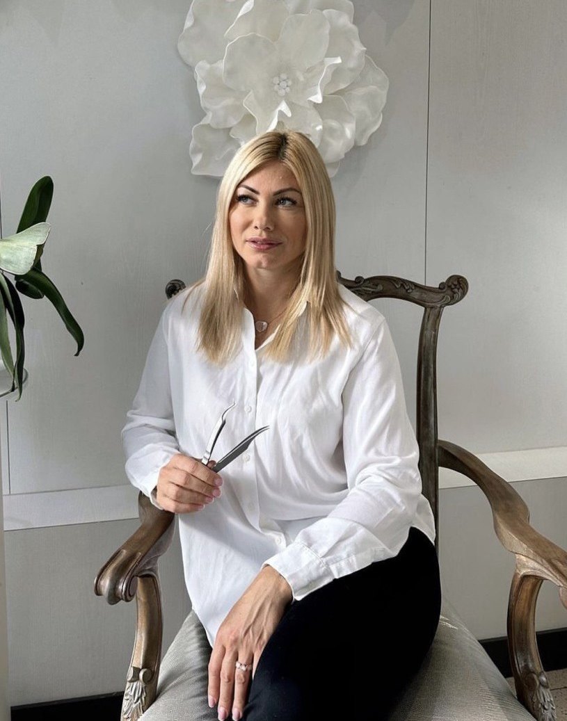 Lana, licensed lash artist, in her studio holding lash tweezers